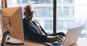 A professional advisor reviewing a digital balance sheet with a business owner to determine enterprise value.