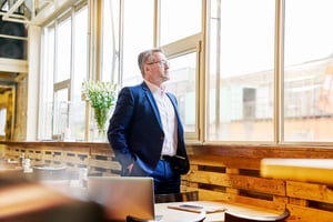 mature-businessman-in-cafe-looking-out-of-window-2026-01-05-00-35-59-utc (1)